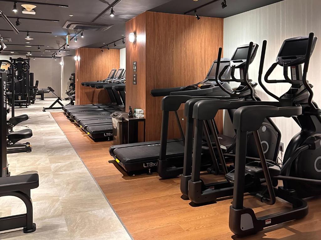 a gym with rows of exercise bikes and treadmills at the b ikebukuro in Tokyo