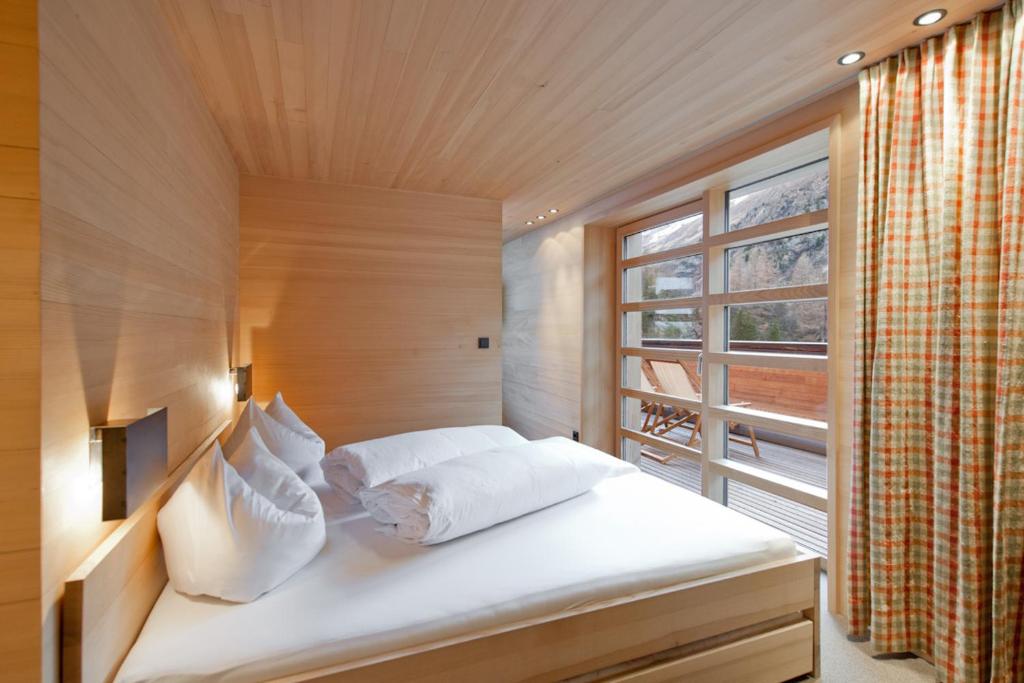 a bedroom with a large bed with a window at Abitare in Obergurgl
