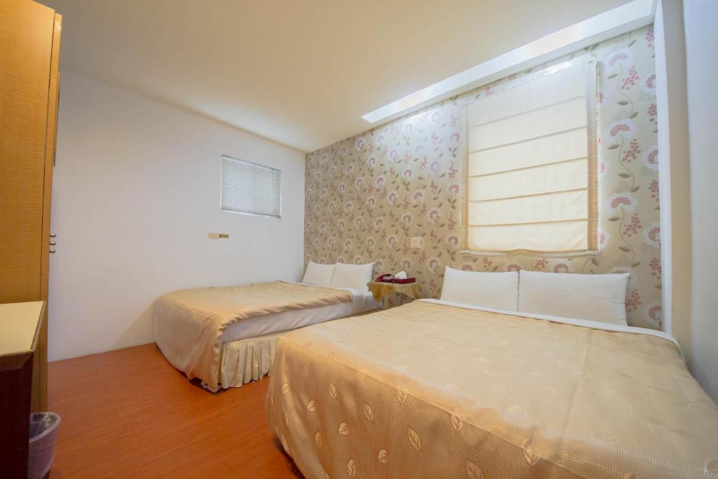 Postel nebo postele na pokoji v ubytování Songyuan B&B