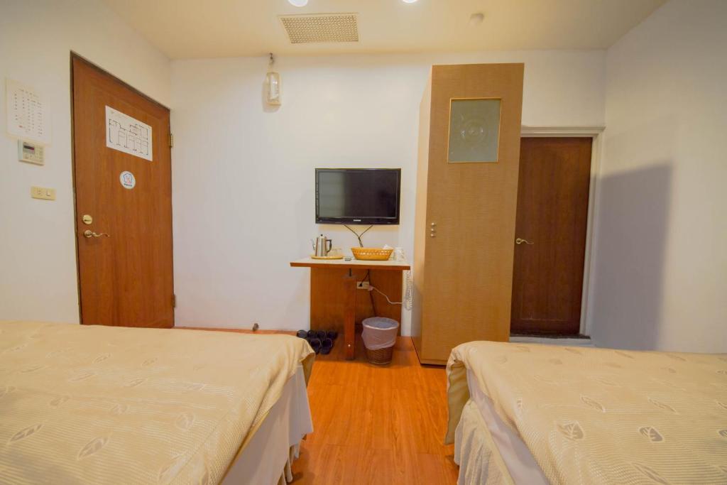 Postel nebo postele na pokoji v ubytování Songyuan B&B