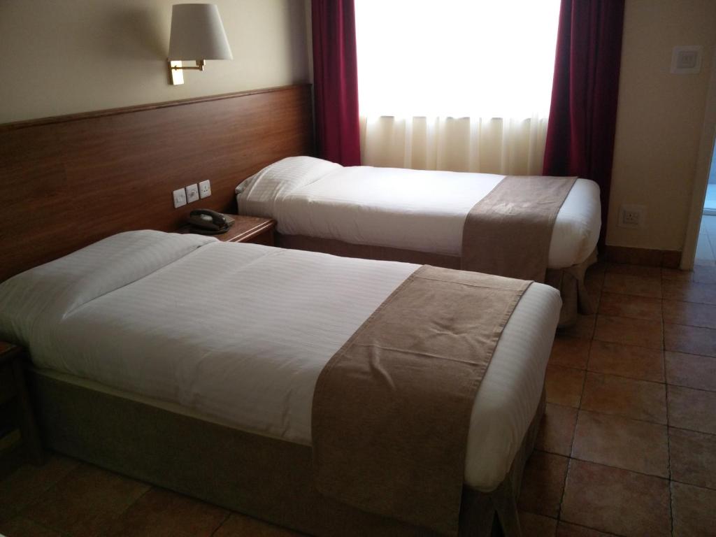 Postel nebo postele na pokoji v ubytování Allegro Hotel