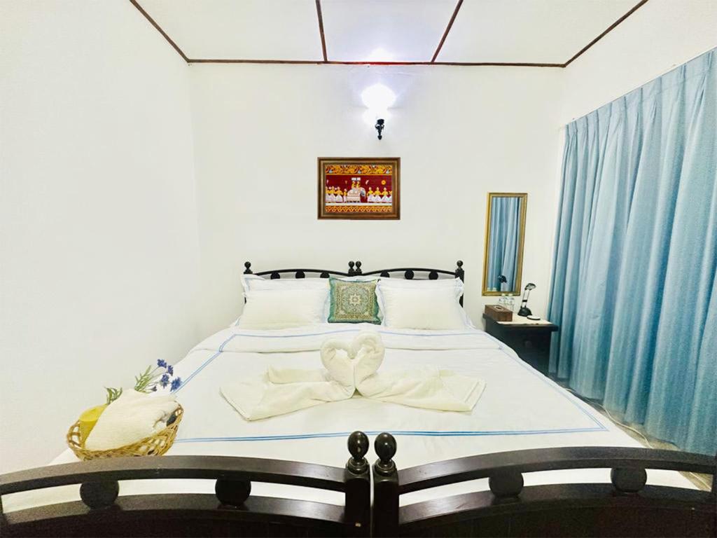 Postel nebo postele na pokoji v ubytování Sea Breeze Guest House Negombo