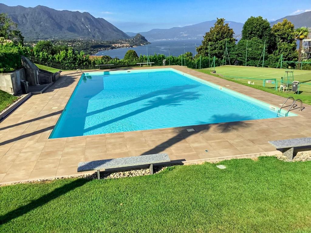 a large swimming pool with a view of the water at Parco Ameno by Lago Reisen in Germignaga