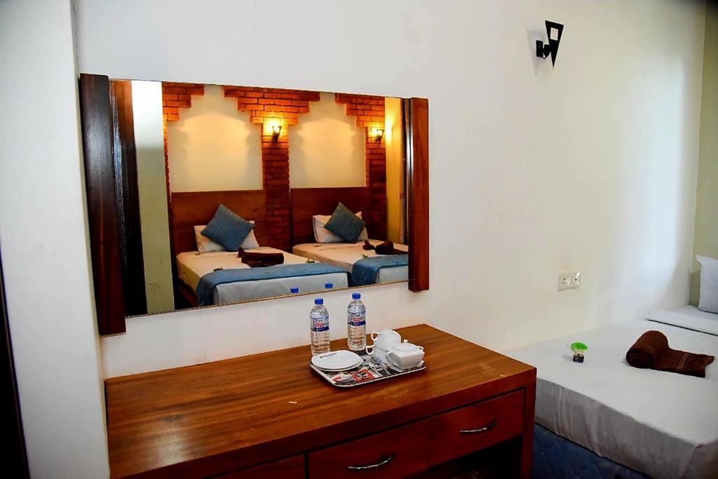 Postel nebo postele na pokoji v ubytování Peacock Eco Resort Sigiriya