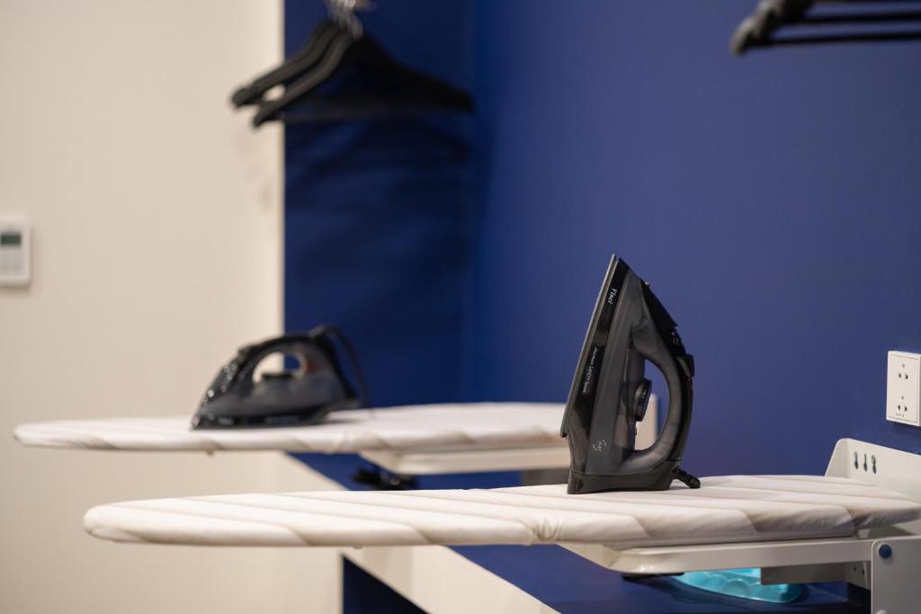 a pair of surfboards on a table in a room at Wink Hotel Tuy Hoa Beach - 24hrs stay & Rooftop Pool Bar in Tuy Hoa