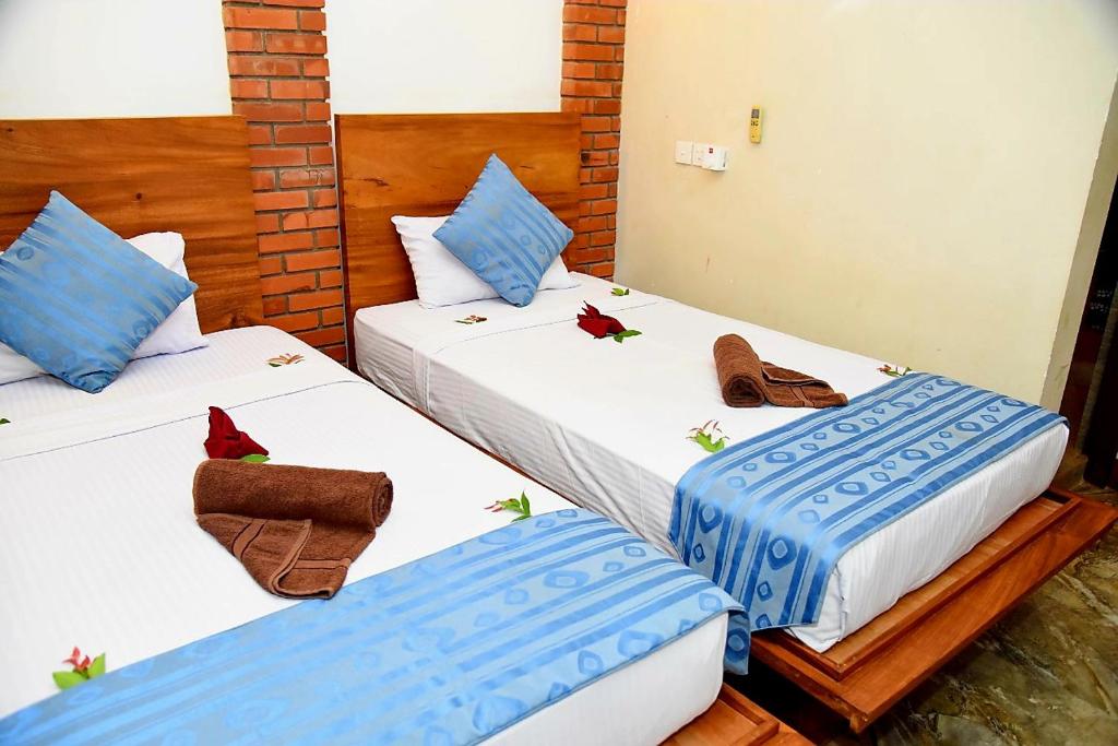 Postel nebo postele na pokoji v ubytování Peacock Eco Resort Sigiriya