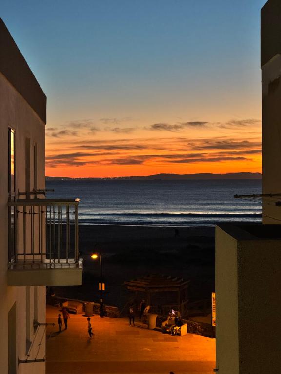a view of the ocean at sunset from a building at Tarifabeach in Tarifa
