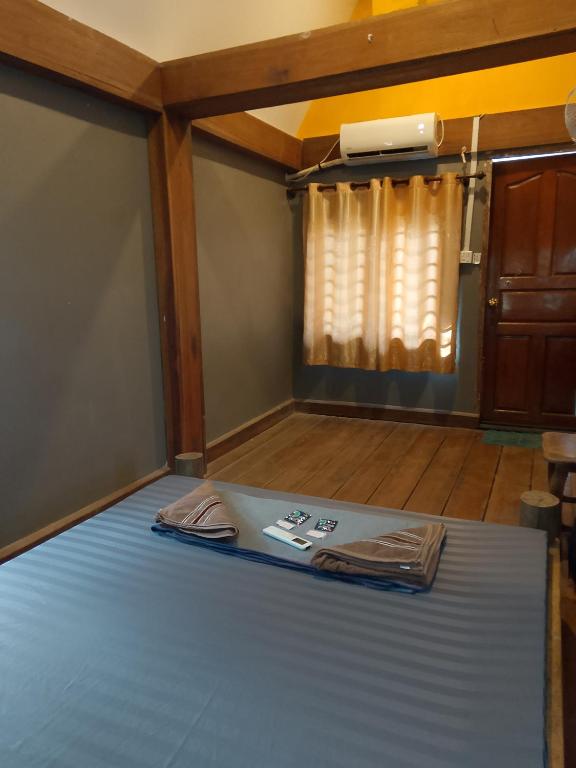 a large bed in a room with a window at Lazy Bones in Koh Rong Sanloem
