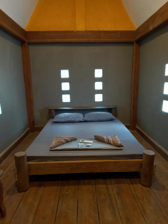 a large bed in a room with windows at Lazy Bones in Koh Rong Sanloem