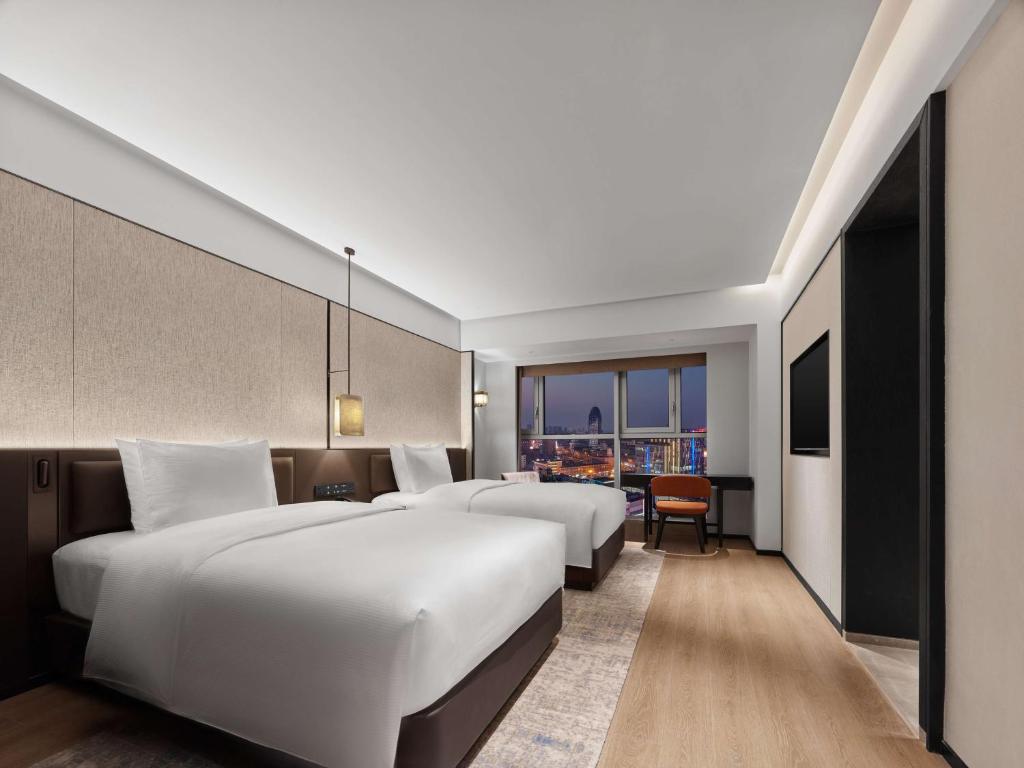 Postel nebo postele na pokoji v ubytování DoubleTree by Hilton Weihai