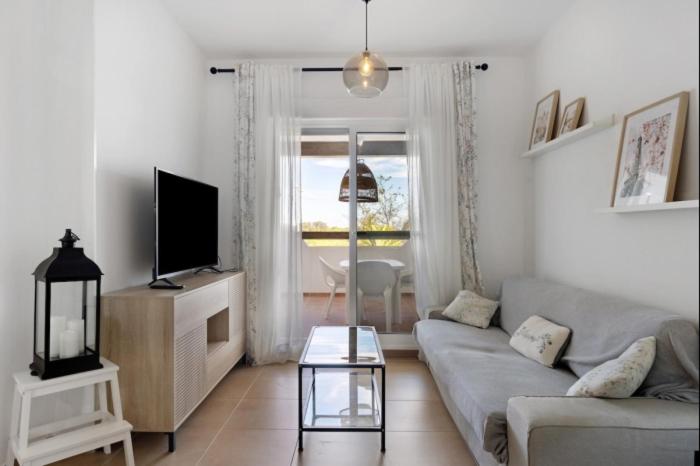 ein Wohnzimmer mit Sofa und Fernseher in der Unterkunft Isla Candor free parking by Staycare in Rota