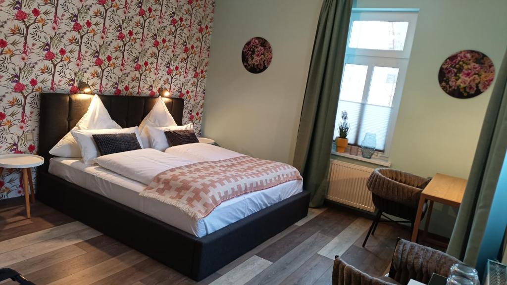 a bedroom with a bed in a room at Hotel Bodethal in Thale