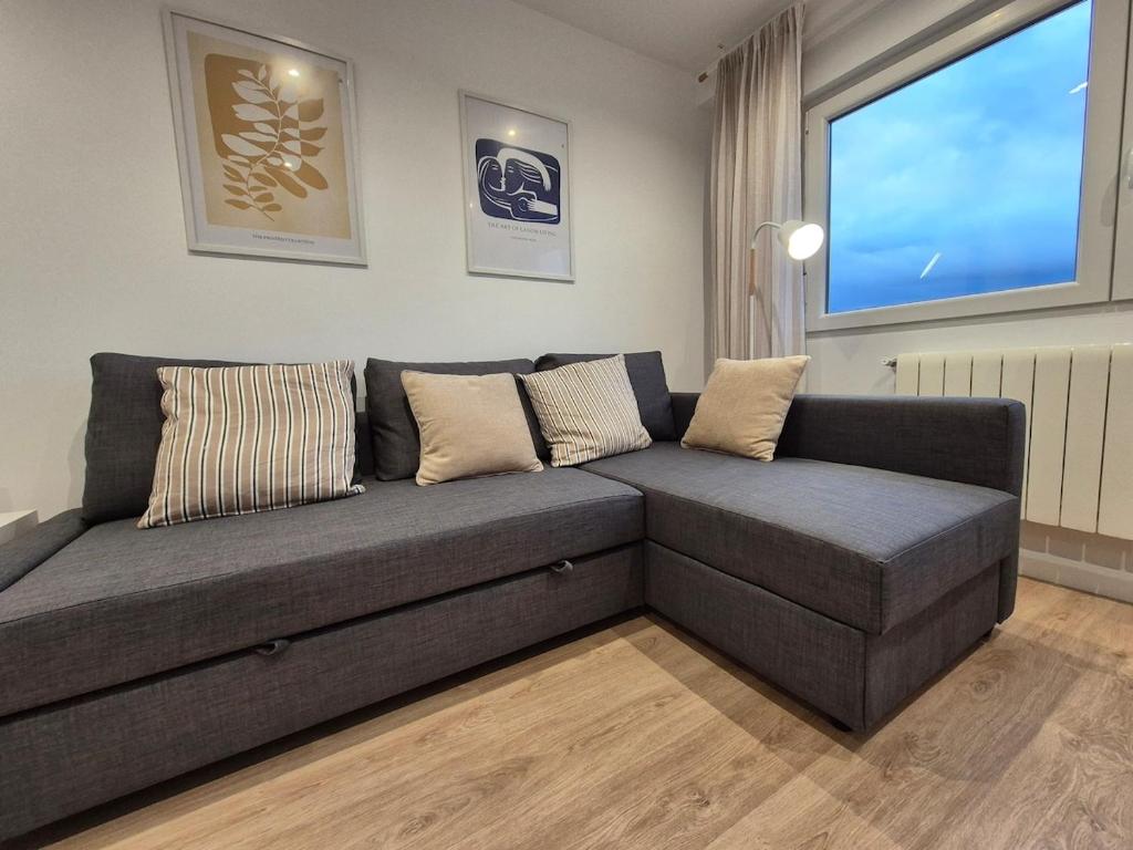 a couch in a living room with a large window at C01A07 Moderno apartamento con vistas in Santander