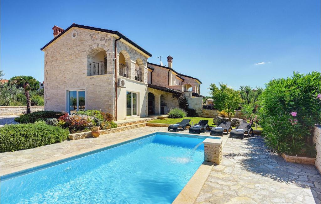an external view of a house with a swimming pool at Villa Macun in Rovinj