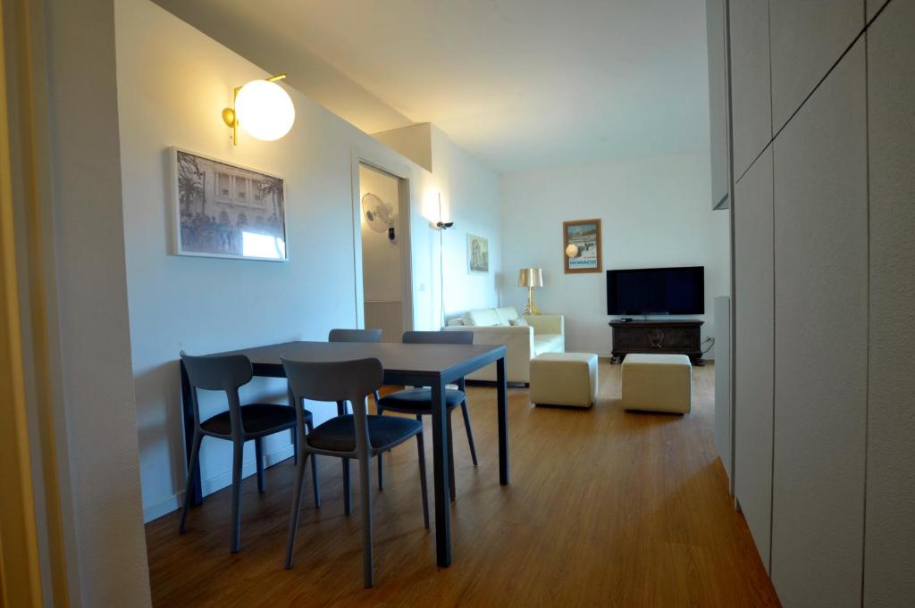 Una mesa de comedor y sillas en una sala de estar. en Maison Adri ' con posto auto privato, en Bussana Nuova