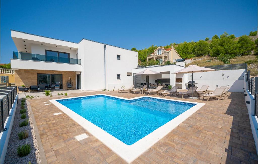 a swimming pool in the backyard of a house at Stunning Home In Zaboric With Sauna in Zaboric