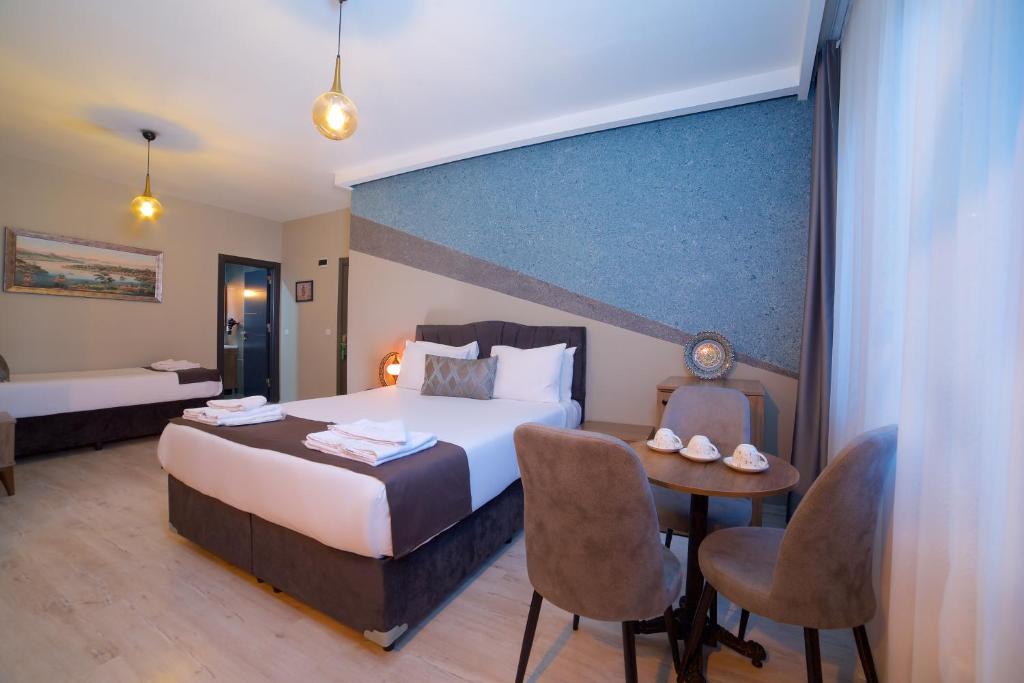 A bed or beds in a room at La Vida Old City Hotel