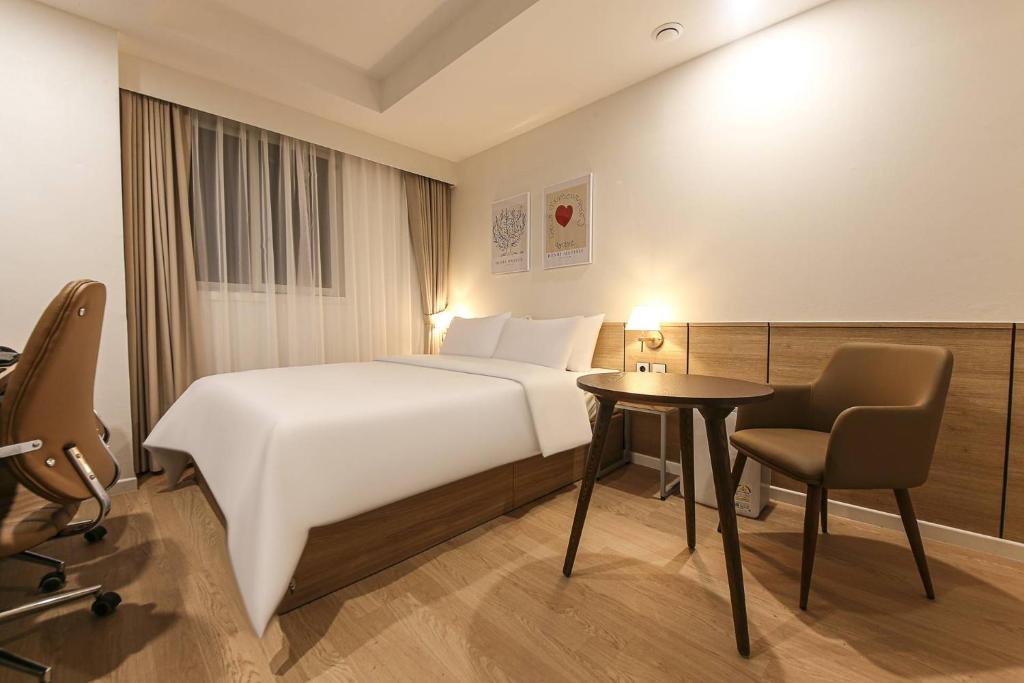 Postel nebo postele na pokoji v ubytování Arentz Hotel