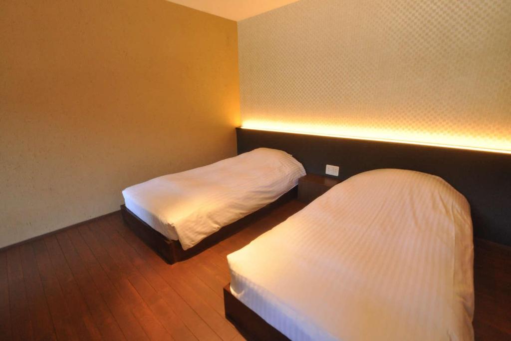 Postel nebo postele na pokoji v ubytování Aura Tachibana