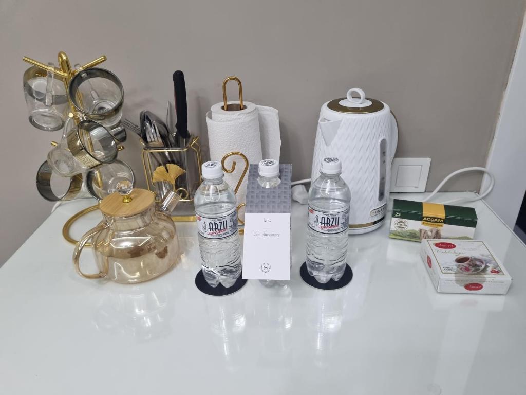 a counter with two bottles of water on it at Стильные апартаменты ближе караван сарая in Türkistan
