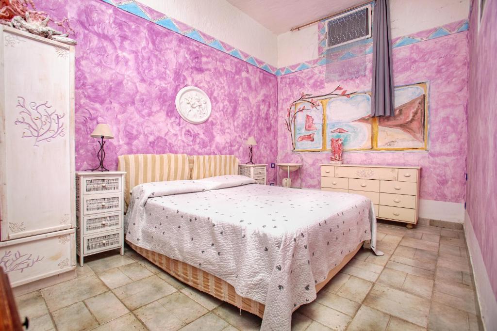Postel nebo postele na pokoji v ubytování Locanda Domus De Vida