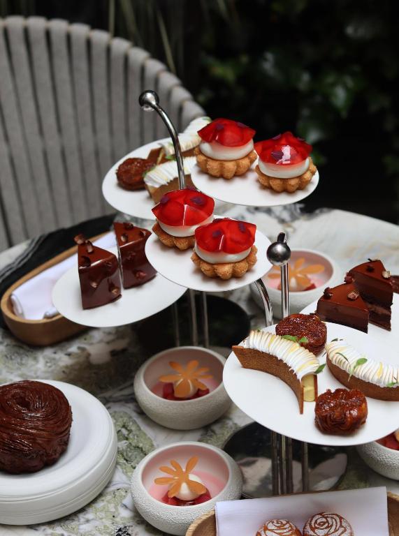 a display of cakes and desserts on a table at Le Burgundy Paris in Paris