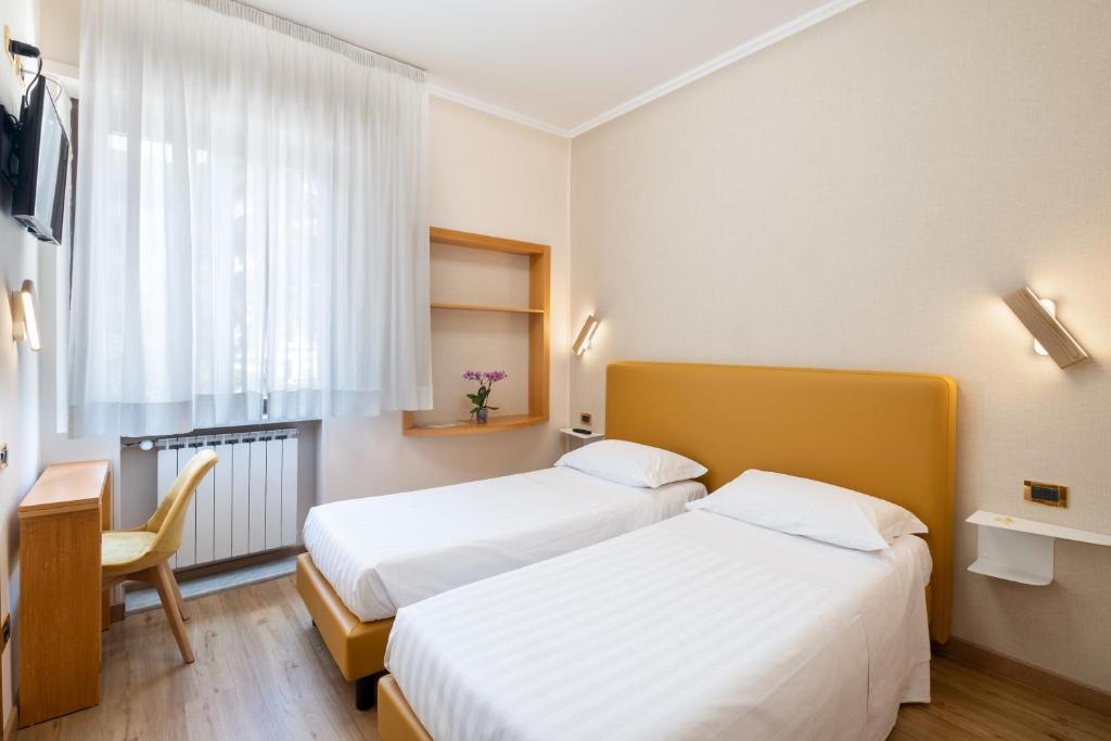 A bed or beds in a room at Hotel Santa Prisca