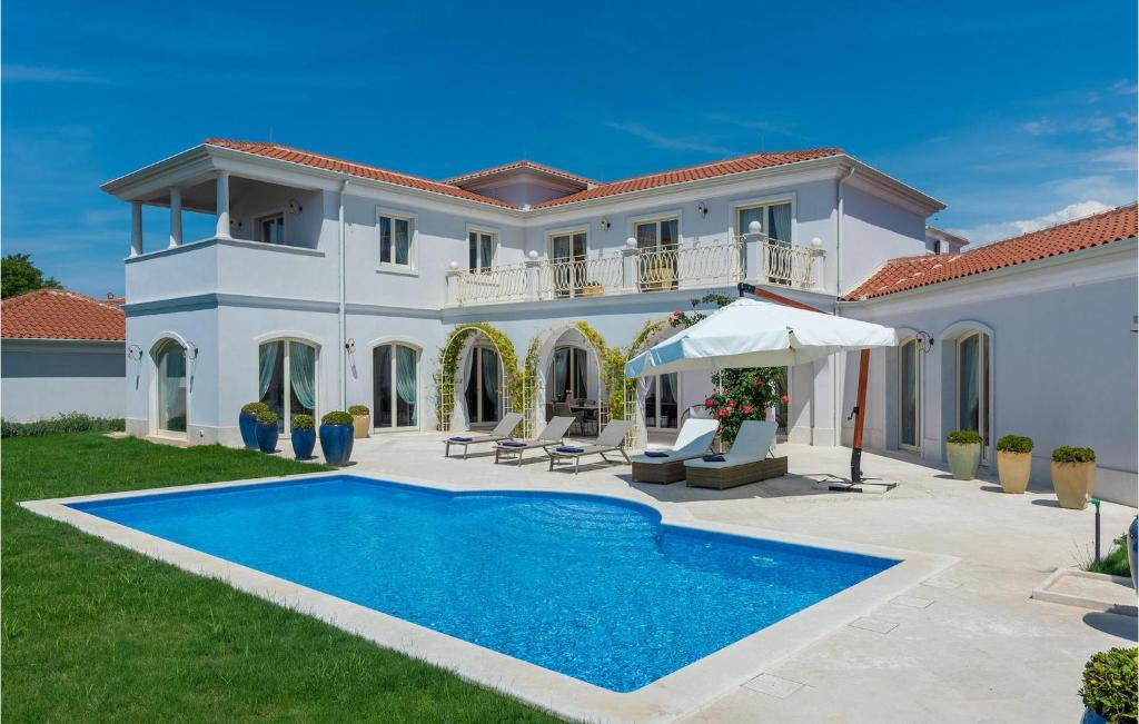 a villa with a swimming pool in front of a house at Villa Lavanda Vabriga in Poreč