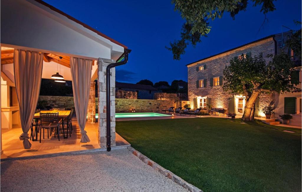 an outdoor patio with a table and a lawn at Villa Luvi in Rovinj