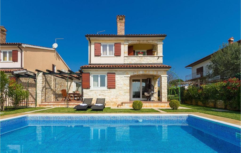 a house with a swimming pool in front of a house at Villa Vera in Poreč