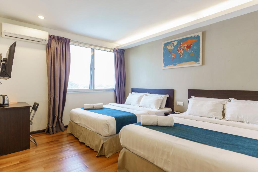 Postel nebo postele na pokoji v ubytování Orange Hotel Kota Kemuning @ Shah Alam