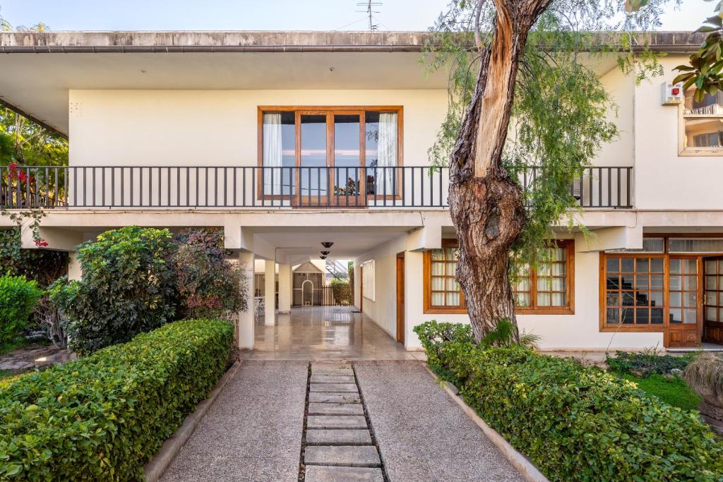 una vista exterior de una casa con un árbol en Villa Palma 2, en Palma de Mallorca