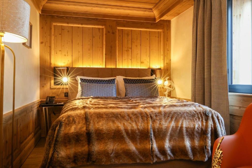 Domaine de Montagne - Hôtel Chalet Frère Josephにあるベッド