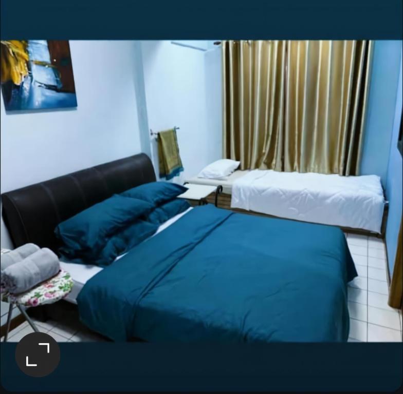 a hotel room with two beds and a window at ZNZ Oasis Homestay in Port Dickson
