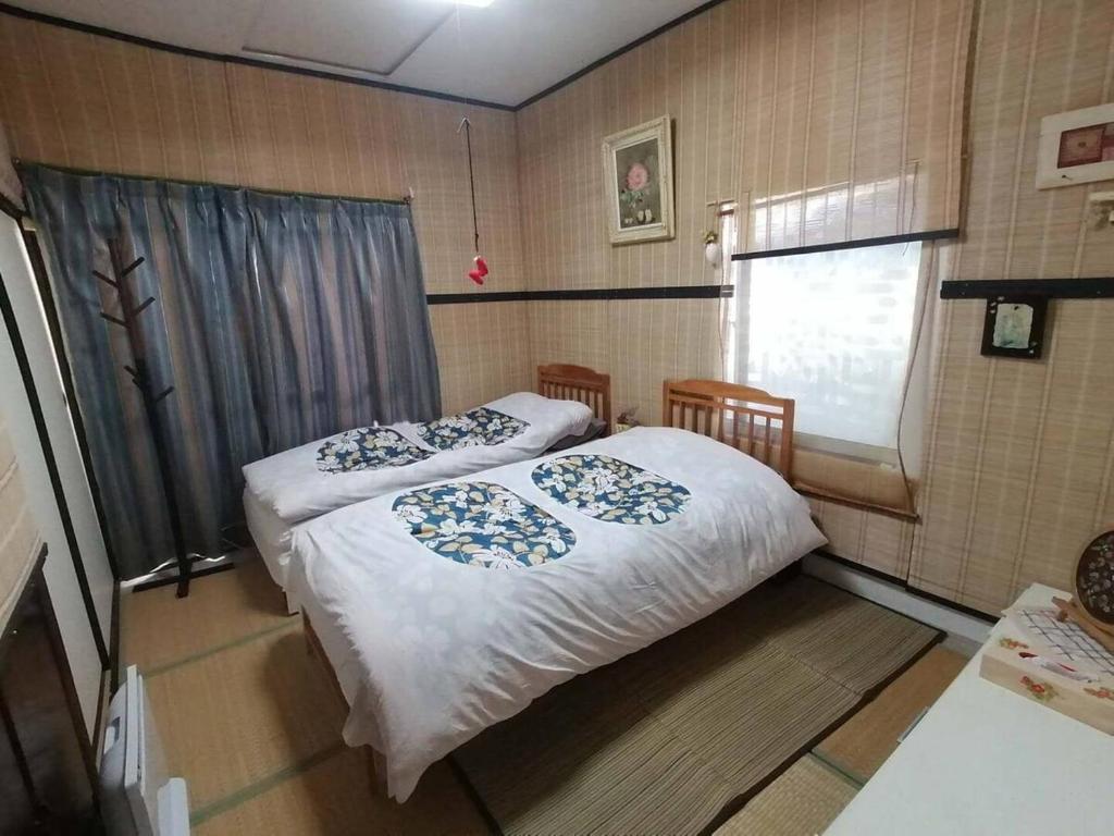 Postel nebo postele na pokoji v ubytování 憩の家丸々貸し