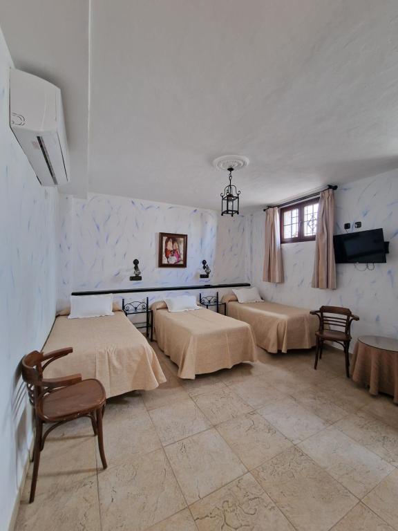 Cama o camas de una habitación en Hospedería El Caravansar