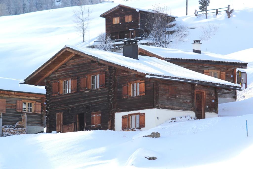una baita con la neve sul tetto di Maiensäss Stafel 45 a Mutten