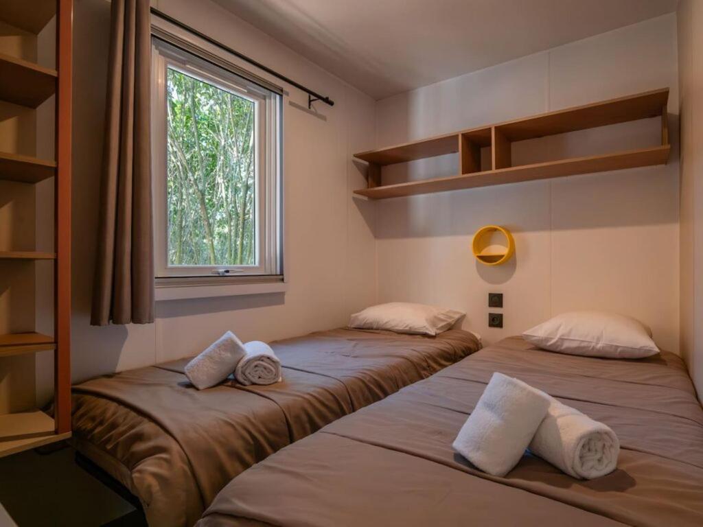 Postel nebo postele na pokoji v ubytování L'Oasis