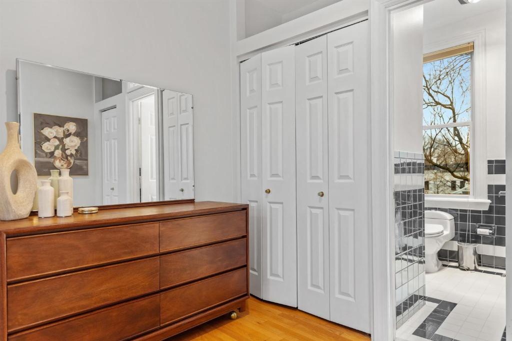 a bathroom with a dresser and a mirror at Spacious and Central DC 3-BR Getaway Close to It All in Washington, D.C.