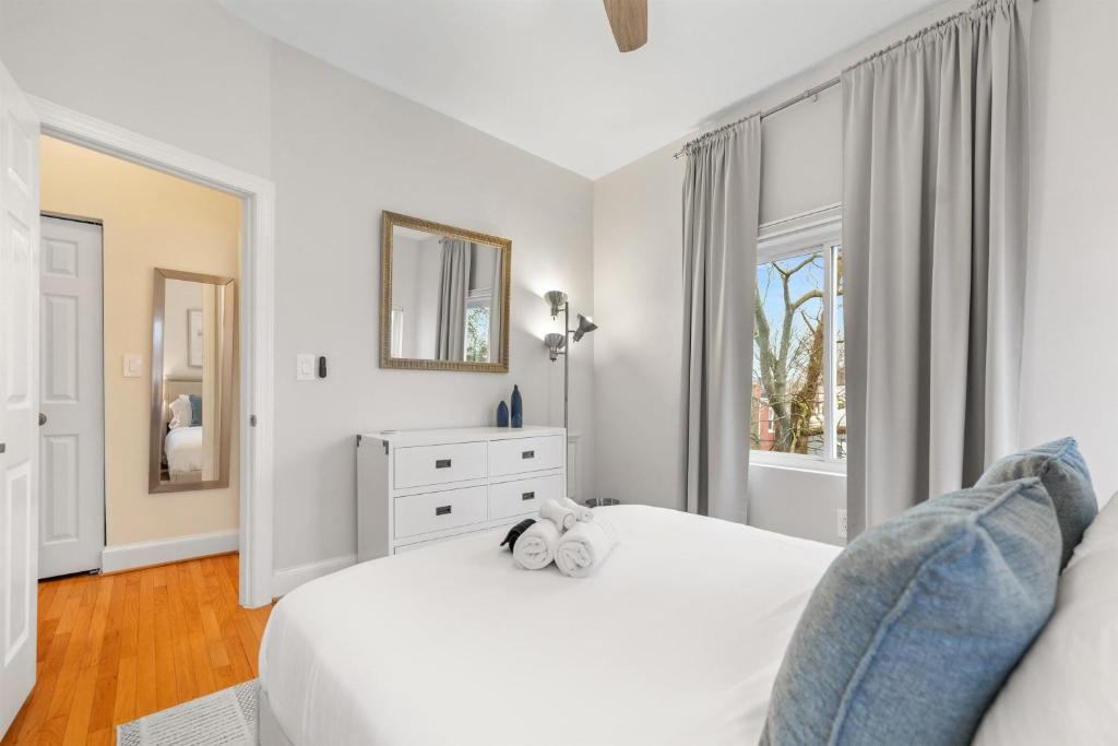 a white bedroom with a white bed and a window at Spacious and Central DC 3-BR Getaway Close to It All in Washington, D.C.