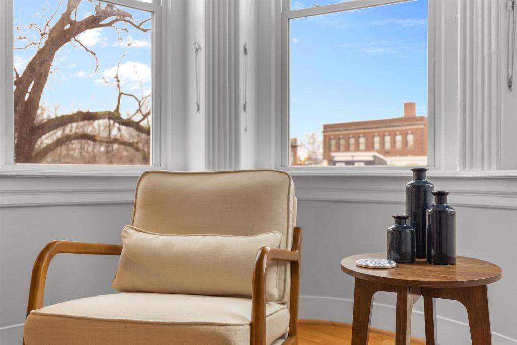 a chair and a table in front of a window at Spacious and Central DC 3-BR Getaway Close to It All in Washington, D.C.