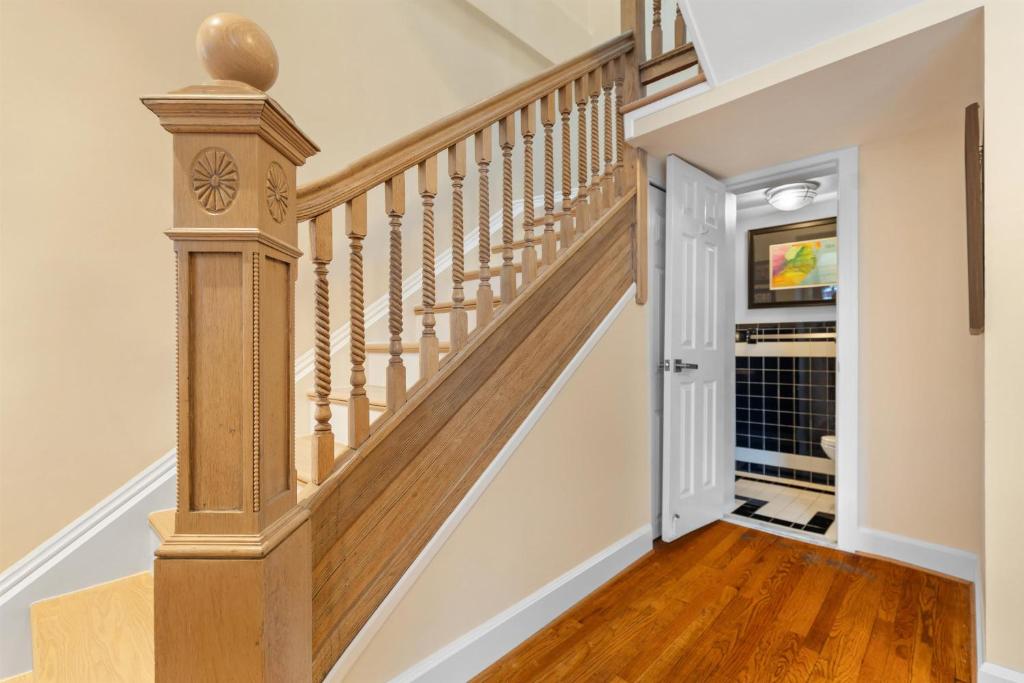 a staircase in a home with wooden floors at Spacious and Central DC 3-BR Getaway Close to It All in Washington, D.C.