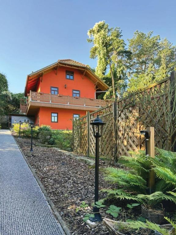 a orange house with a fence in front of it at Nicole in Quedlinburg