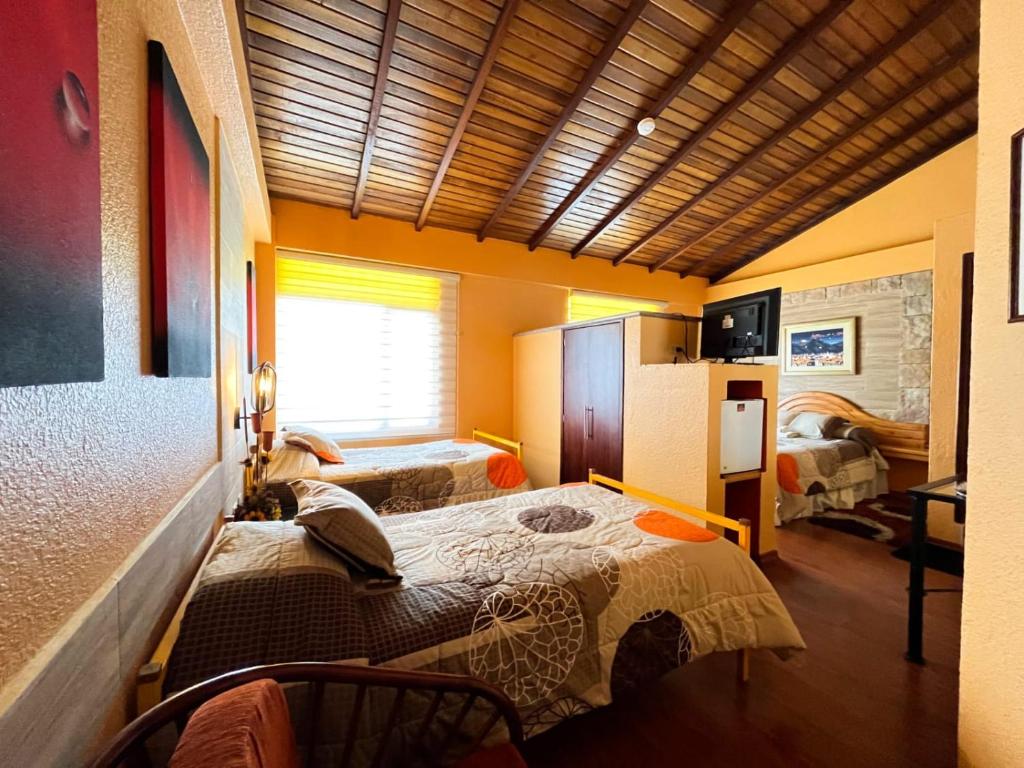 Postel nebo postele na pokoji v ubytování Hotel Rodelu