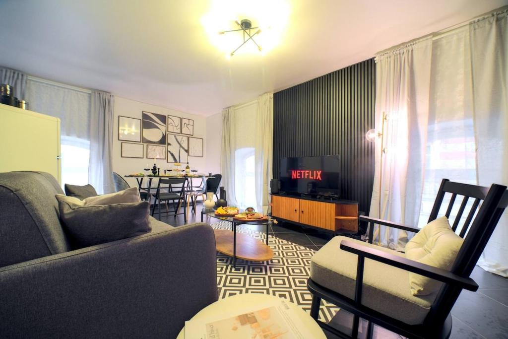 un salon avec un canapé et une salle à manger dans l'établissement Superbe appartement contemporain Mulhouse Centre, à Mulhouse