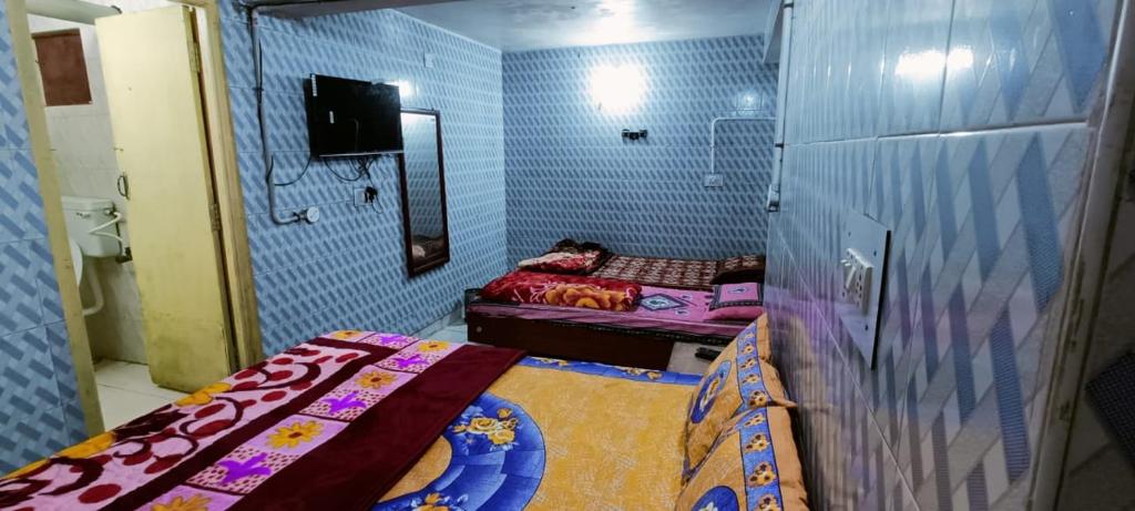 Postel nebo postele na pokoji v ubytování Mananyaa Residency