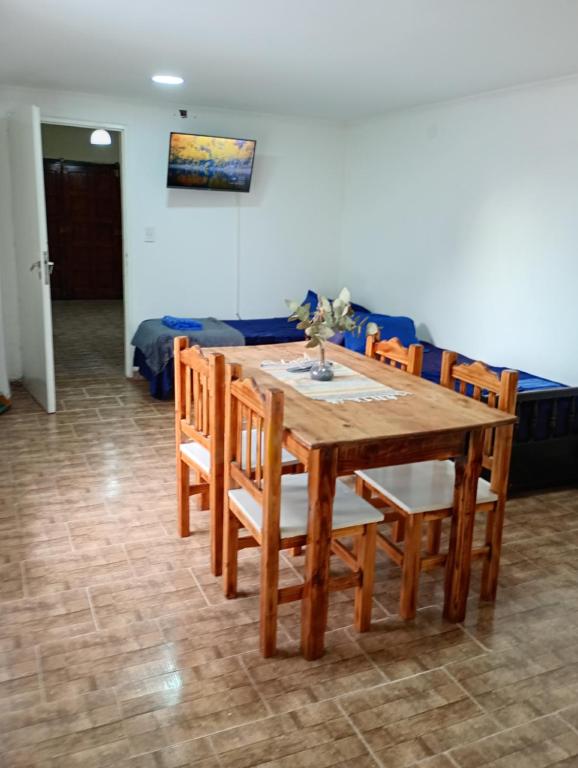 a wooden table and chairs in a living room at La Casita in Mar del Plata