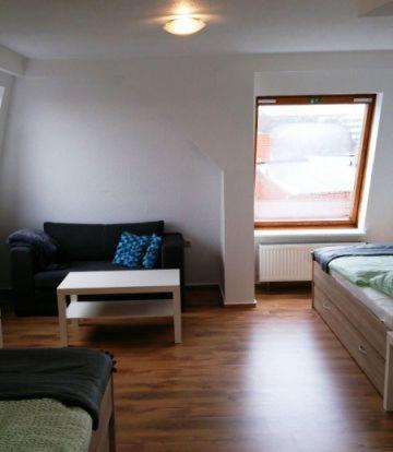a living room with a couch and a table at Rickmersstraße 61 Bremerhaven in Bremerhaven