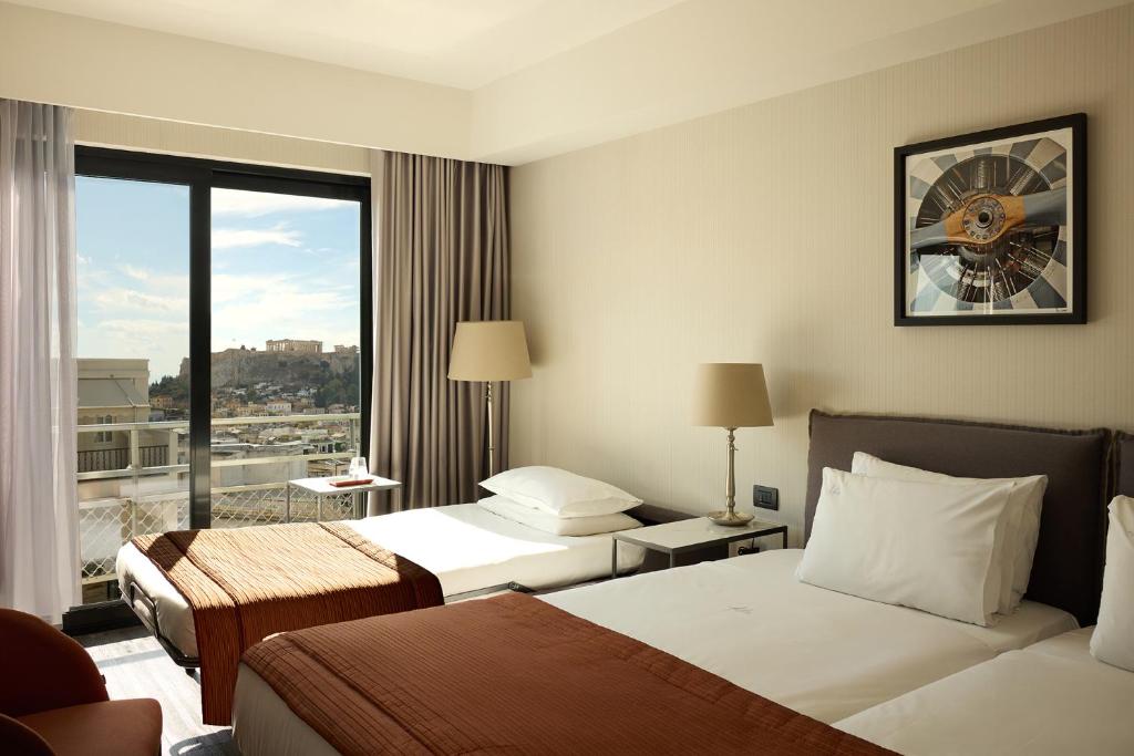 Posteľ alebo postele v izbe v ubytovaní Astor Hotel Athens