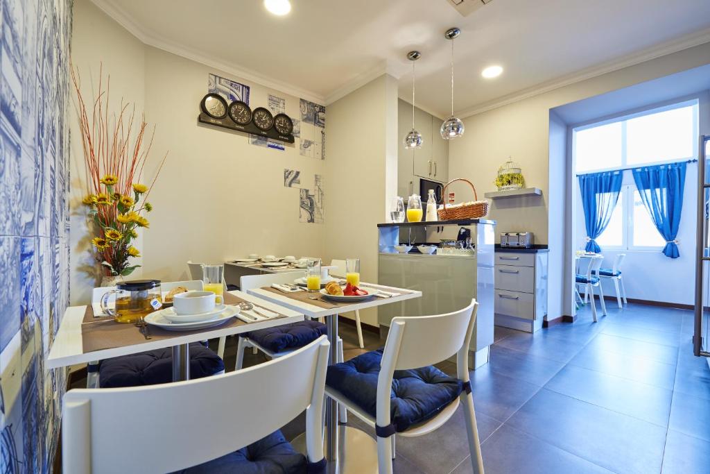 a kitchen and dining room with a table and chairs at Silk Lisbon in Lisbon